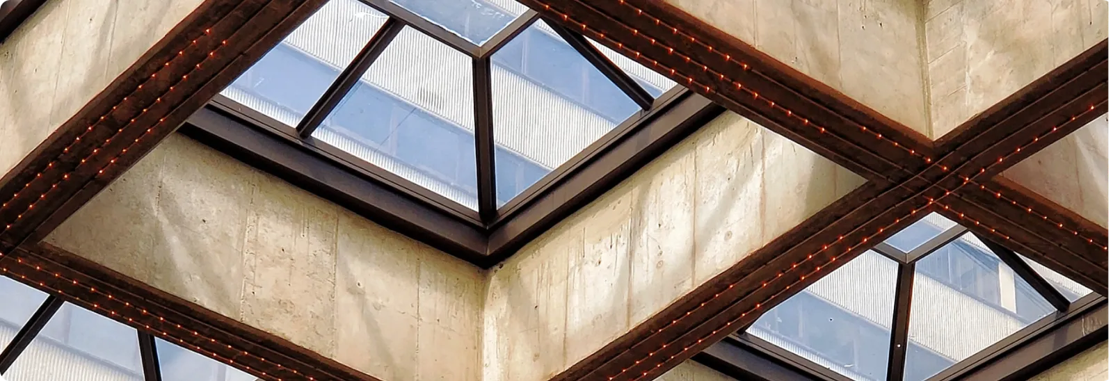 Modern architectural skylight with geometric steel beams and glass panels, representing the structural foundations of alternative investing