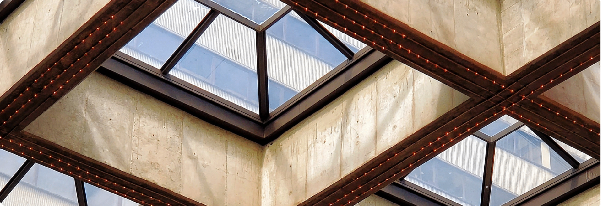 Modern architectural skylight with geometric steel beams and glass panels, representing the structural foundations of alternative investing