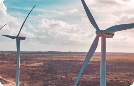Wind turbines against a clear sky, representing ESG and sustainable investing