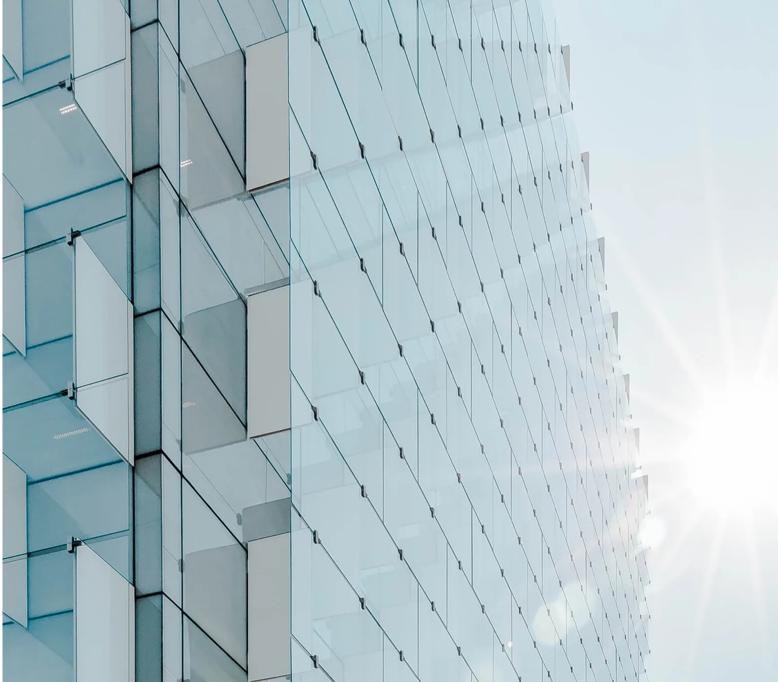 Modern glass office building reflecting sunlight, representing the corporate world of private equity
