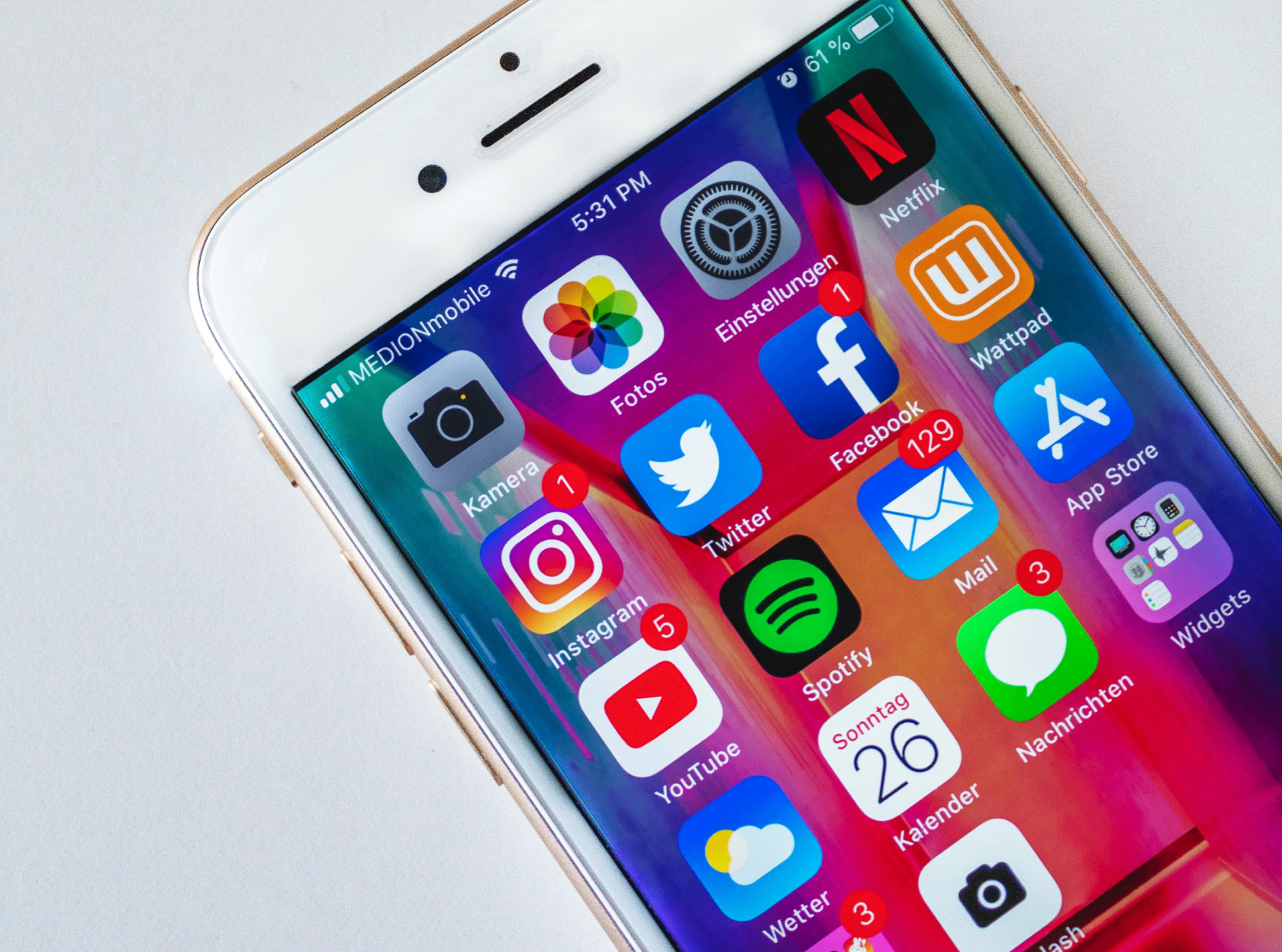 Smartphone showing popular app icons including Netflix, Instagram, and Spotify